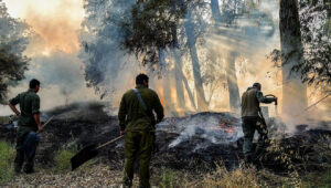 Mitglieder eines Notfallteams versuchen, ein Feuer zu löschen, das durch von der Hisbollah abgefeuerte Raketen in der Nähe der nordisraelischen Stadt Kiryat Shmona verursacht wurde, 4. Juni 2024. Foto von Ayal Margolin/Flash90.